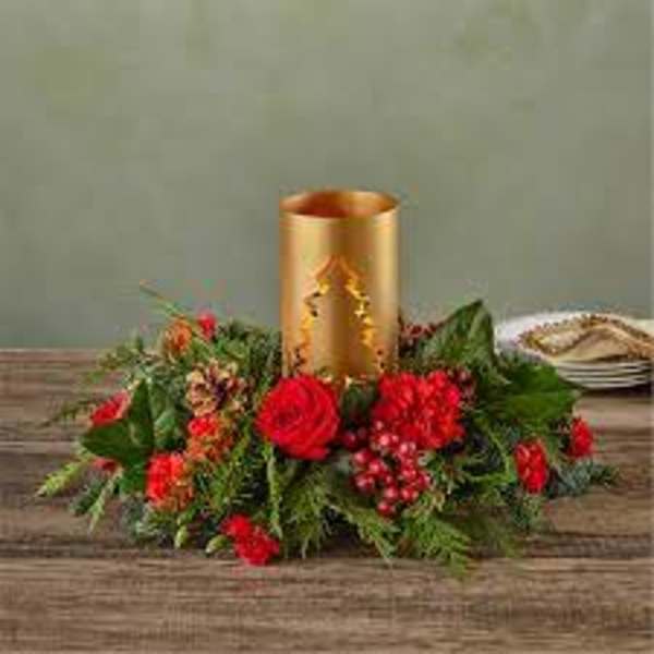 Red floral centerpiece around a gold candle holder