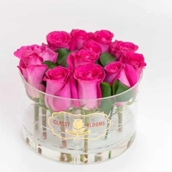Pink roses arranged in a clear round vase