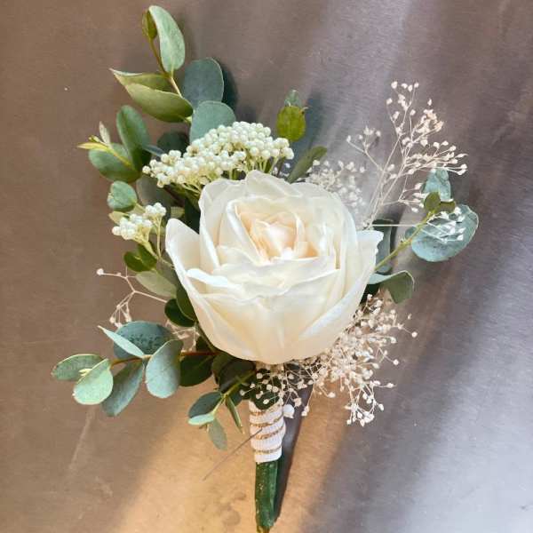 White rose boutonniere with eucalyptus and baby's breath
