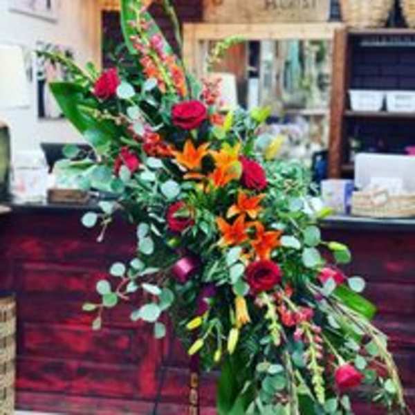 Tall floral spray with red roses and orange lilies