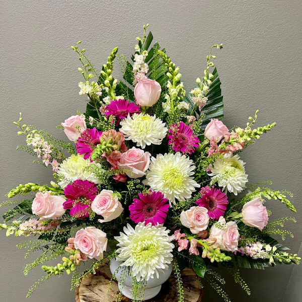Pink roses and white chrysanthemums in a white vase