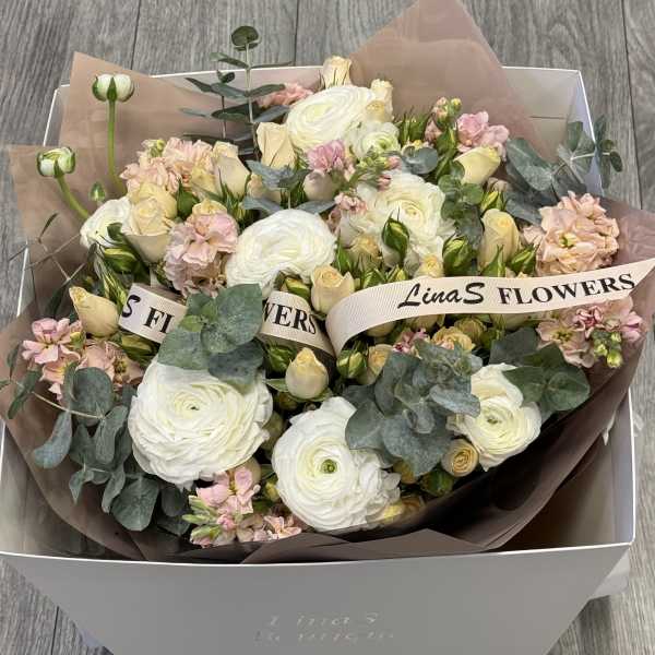 Bouquet of white and blush flowers in a gift box