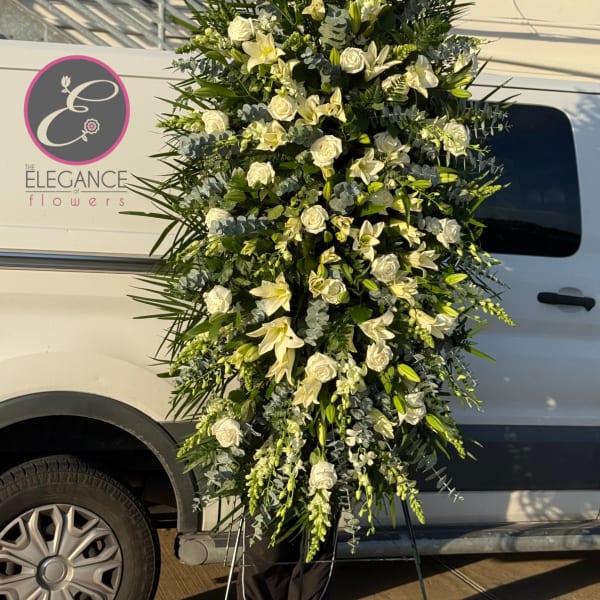 Tall white floral standing spray with roses and lilies