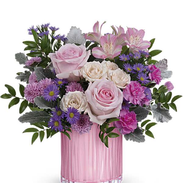 Pink and cream flower arrangement in a pink glass vase