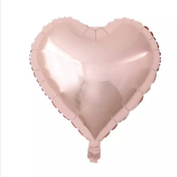 Pink heart-shaped foil balloon on a white background