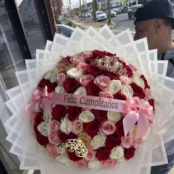Large bouquet of red, pink, and white roses with a birthday ribbon