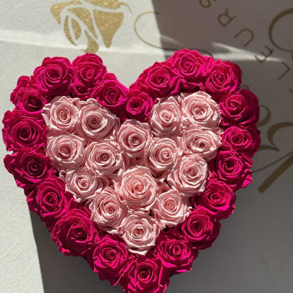 Heart-shaped arrangement of pink and hot pink roses