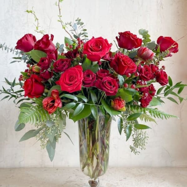 Red rose arrangement in a clear glass vase