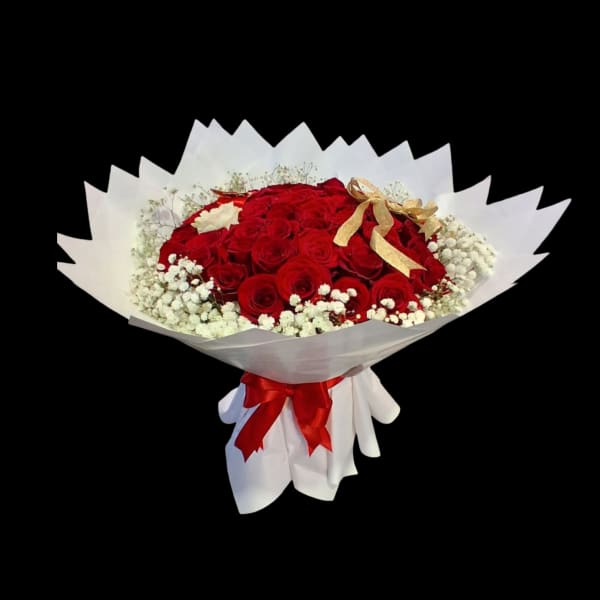 Bouquet of red roses with white baby's breath and a gold ribbon