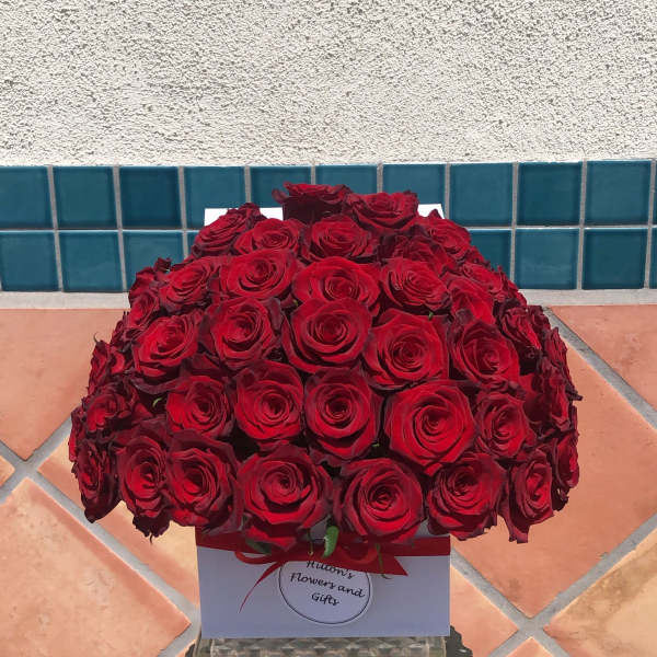 Large bouquet of red roses in a white gift box with a red ribbon