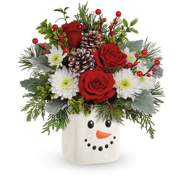 Christmas bouquet in a snowman vase with red roses and white daisies