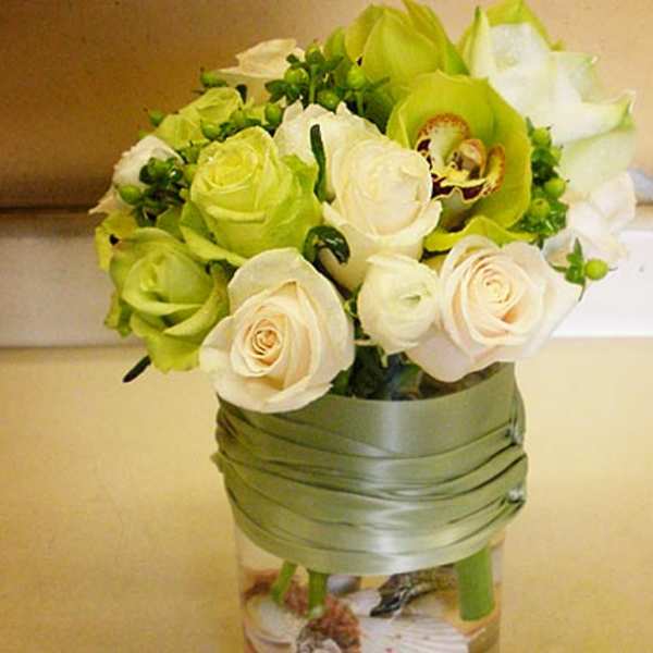 Bouquet of white and green roses in a glass vase