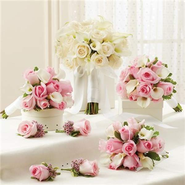 Pink and white rose bouquets with calla lilies and ribbon