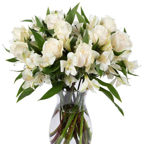Arrangement of white roses and alstroemeria in a clear glass vase