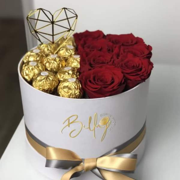 Red roses and gold-wrapped chocolates in a white hat box with a heart topper