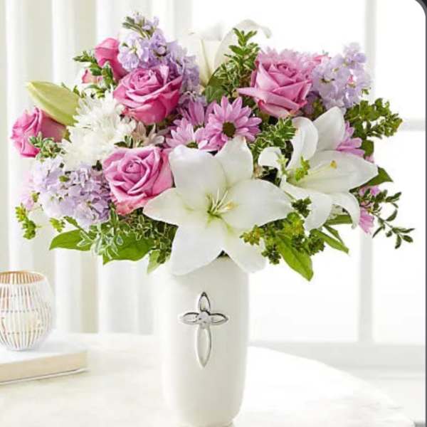 Pink roses and white lilies in a white vase