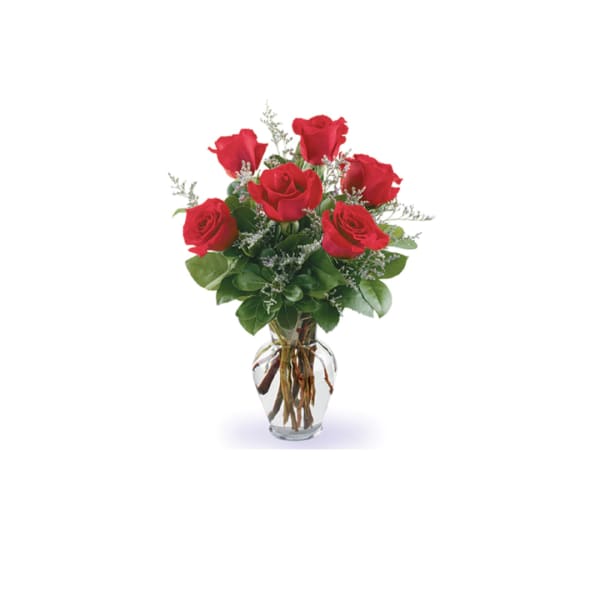 Red roses arranged in a clear glass vase