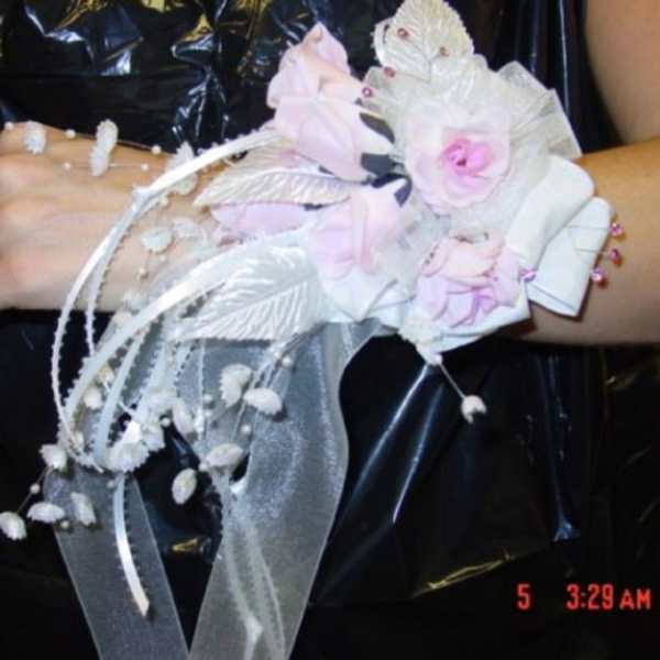 Pink and white floral wrist corsage with ribbon streamers