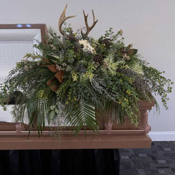Large casket spray with antlers and mixed greenery