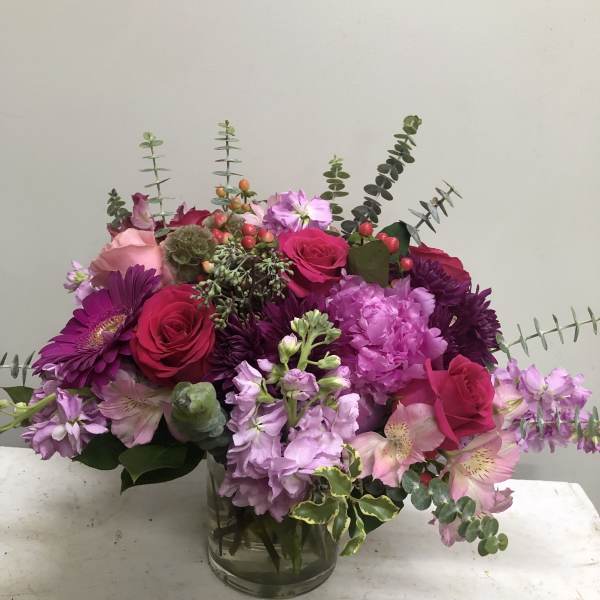 Pink and purple mixed bouquet in a glass vase