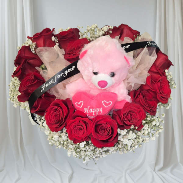 Red rose bouquet with a pink teddy bear and heart decoration