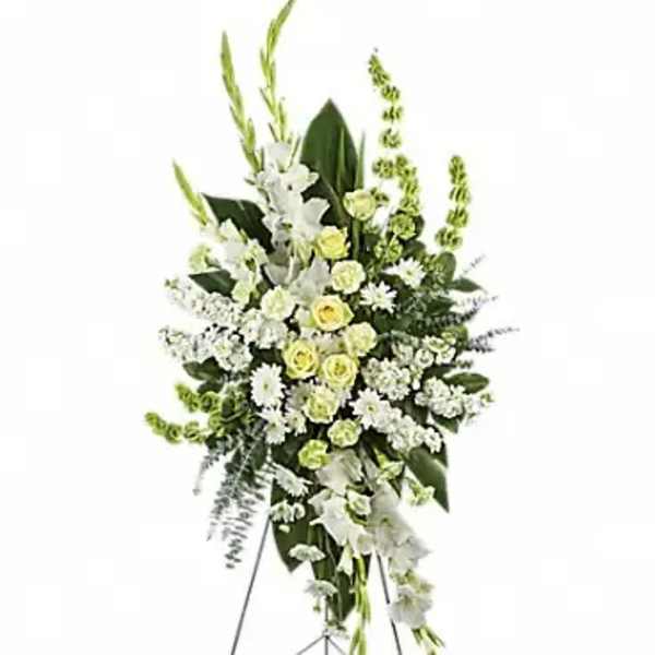 Standing floral spray of white and pale yellow flowers on an easel