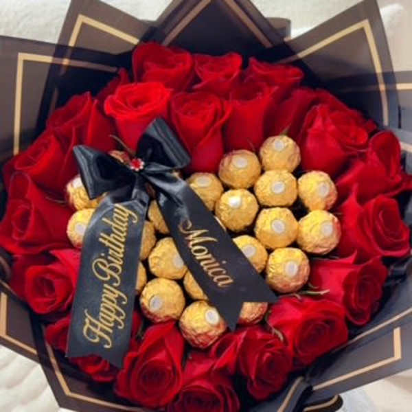 Red rose bouquet with gold chocolates and a birthday ribbon