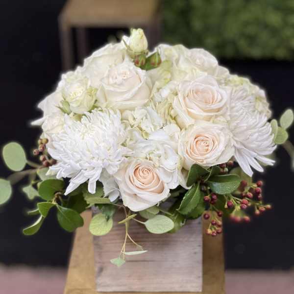 White and blush rose bouquet with white chrysanthemums in a wooden box