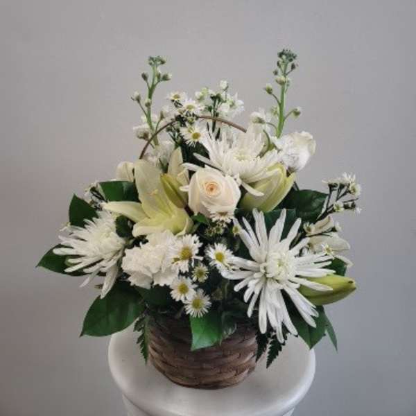 White floral arrangement in a woven basket