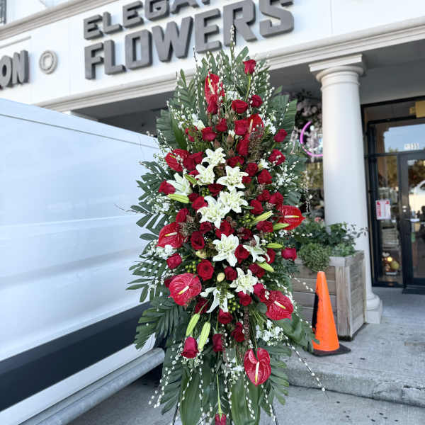 Tall standing floral spray with red roses and white lilies