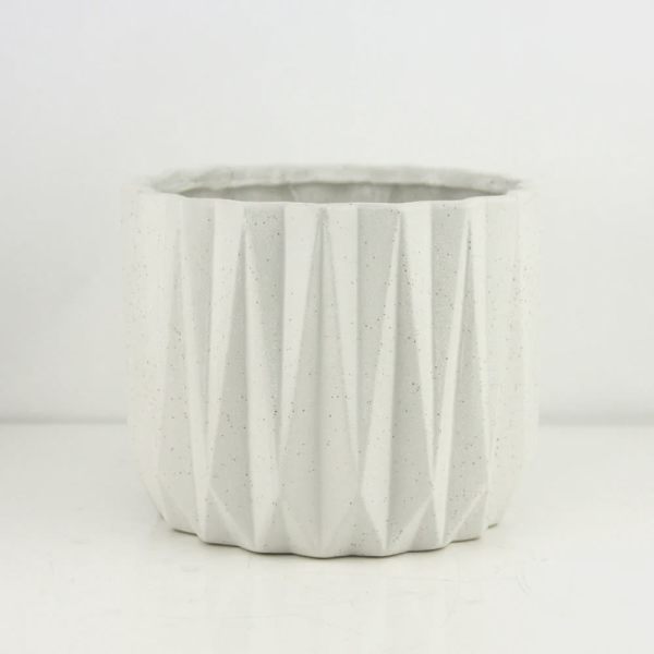 White faceted ceramic planter pot on a plain background