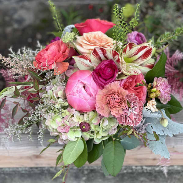 Mixed bouquet of pink and peach flowers with striped blooms