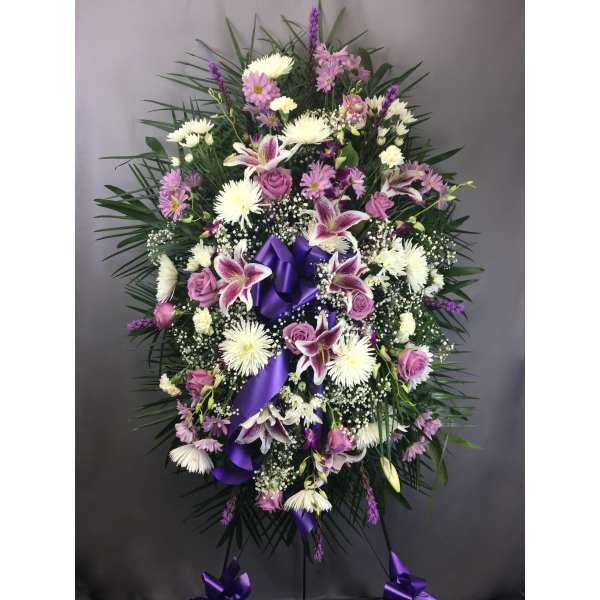 Standing floral spray with purple ribbon and pink-white flowers