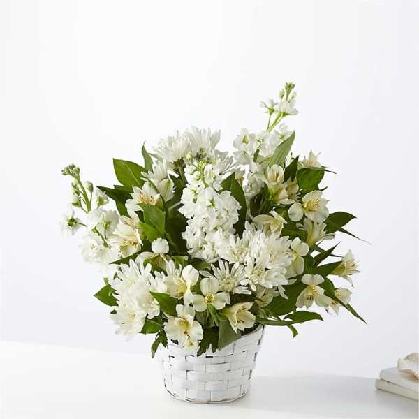 White flowers arranged in a white woven basket