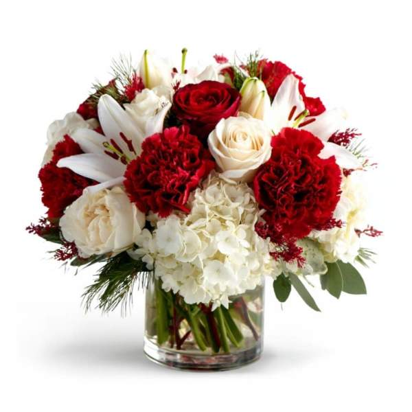 Red and white flower arrangement in a clear glass vase