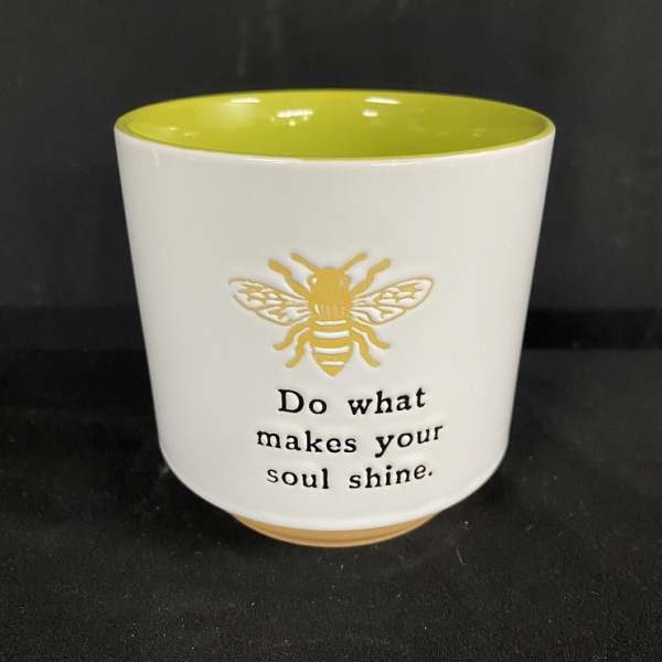 White ceramic pot with a bee graphic and inspirational text