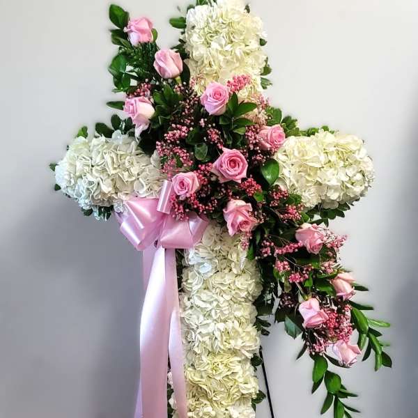 Cross-shaped floral standing spray with pink roses and white hydrangeas