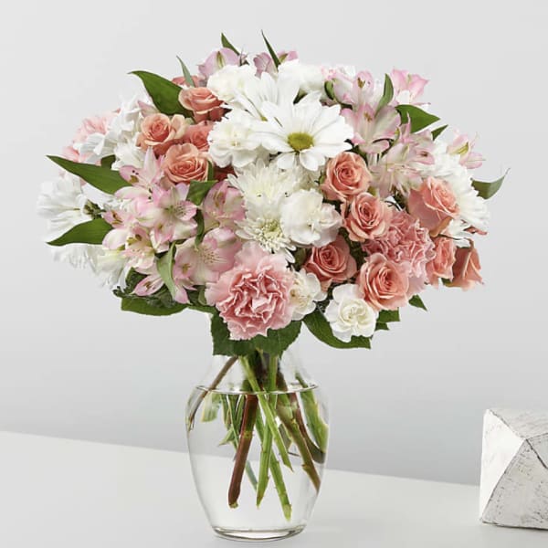 Pink and white mixed bouquet in a clear glass vase