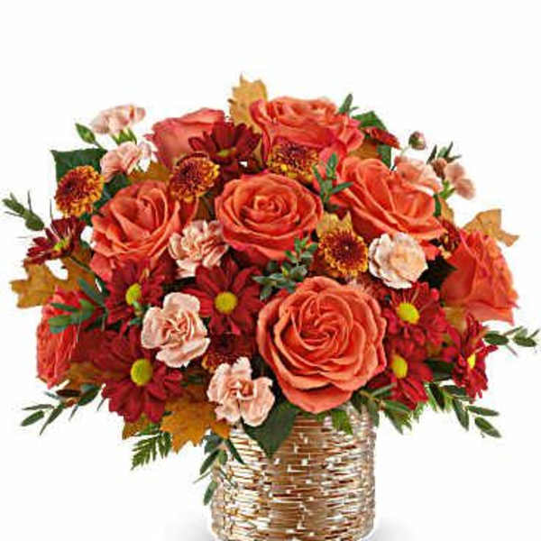 Orange roses and red mums in a woven basket