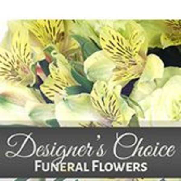Yellow and white funeral flowers with a designer's choice label