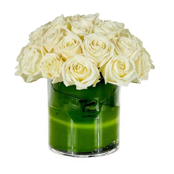 White roses arranged in a clear glass vase
