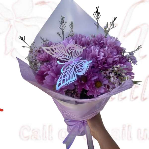 Purple bouquet with butterfly decorations and ribbon wrap