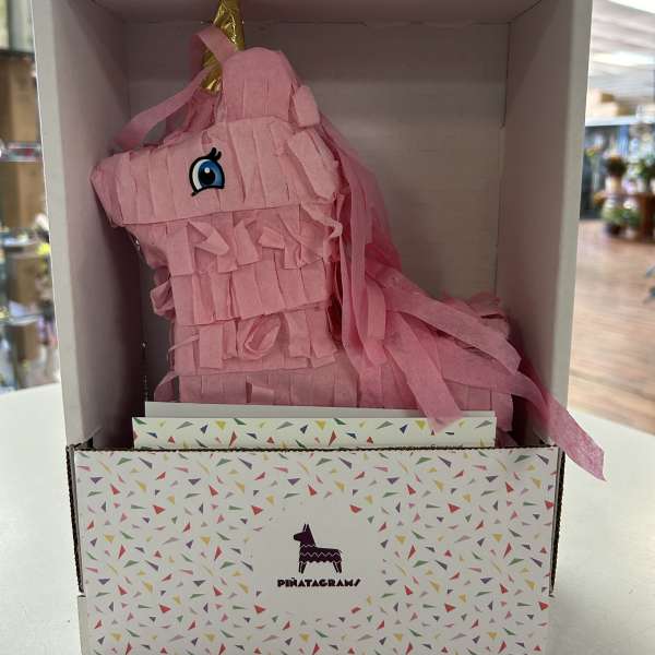 Pink unicorn piñata in a display box