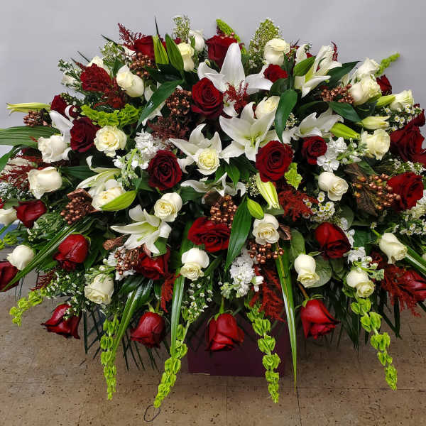 Large red and white floral spray with roses and lilies
