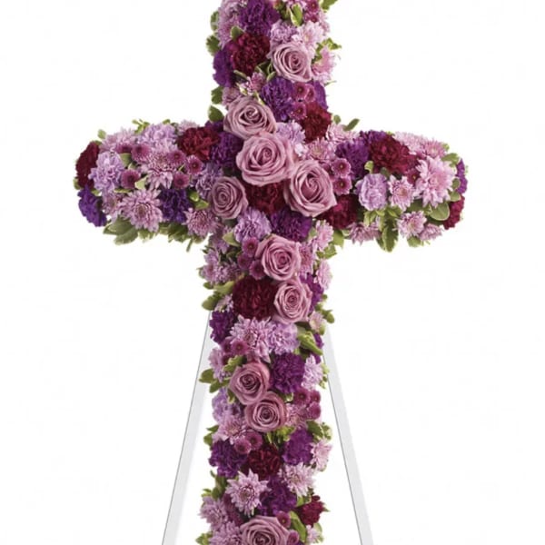 Purple and pink floral cross on a white easel