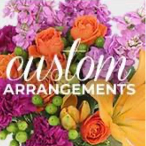 Colorful floral arrangement with orange roses and purple flowers