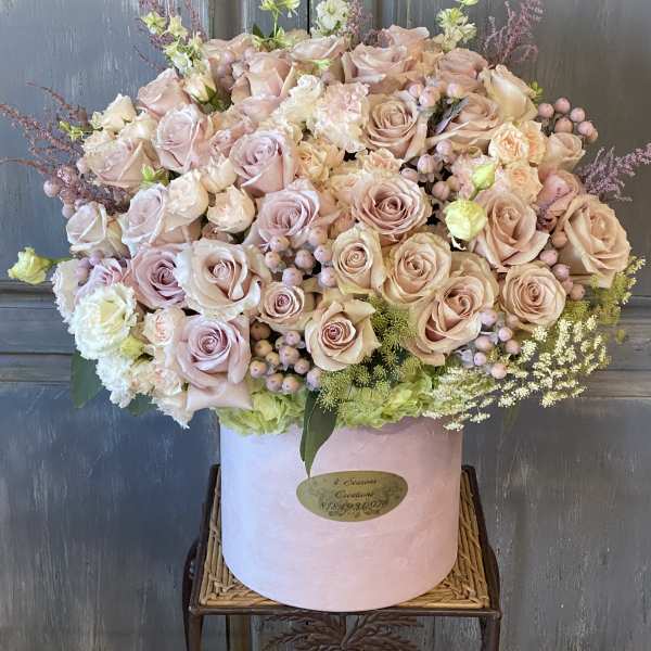 Large blush rose arrangement in a pink hat box