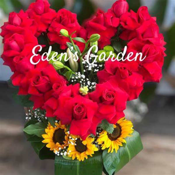 Heart-shaped bouquet of red roses with sunflowers at the base