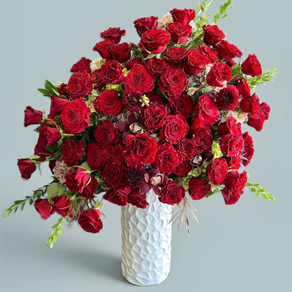 Red rose bouquet in a white textured vase