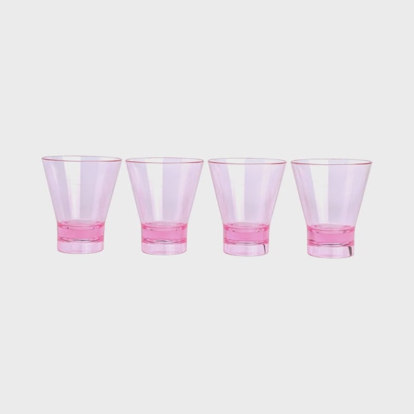 Four translucent pink plastic cups on a white background